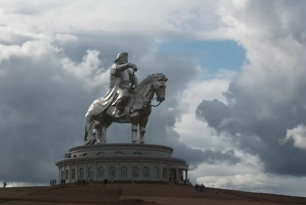The giant steel statue of Chinggis Khaan on horseback under a stormy sky