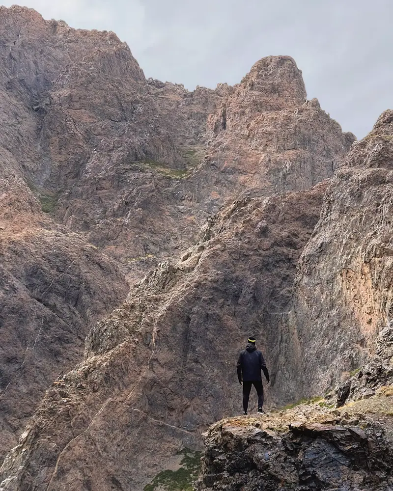 A hiker on the rocks above the Yolyn Am gorge