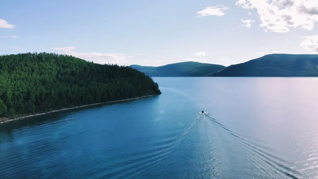 Deep blue water and forested hills on Lake Khövsgöl