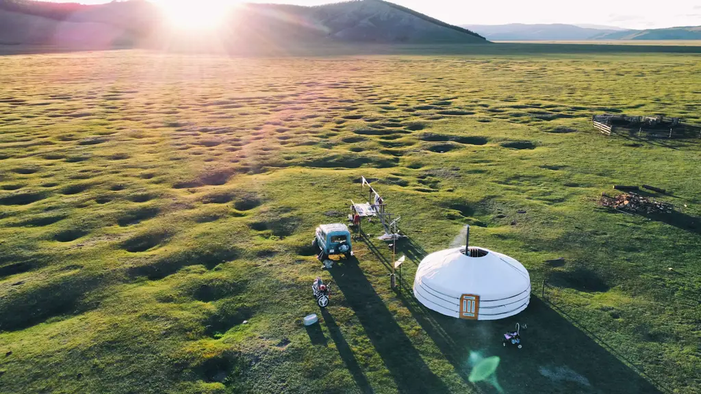 Sunrise over a ger on open pasture