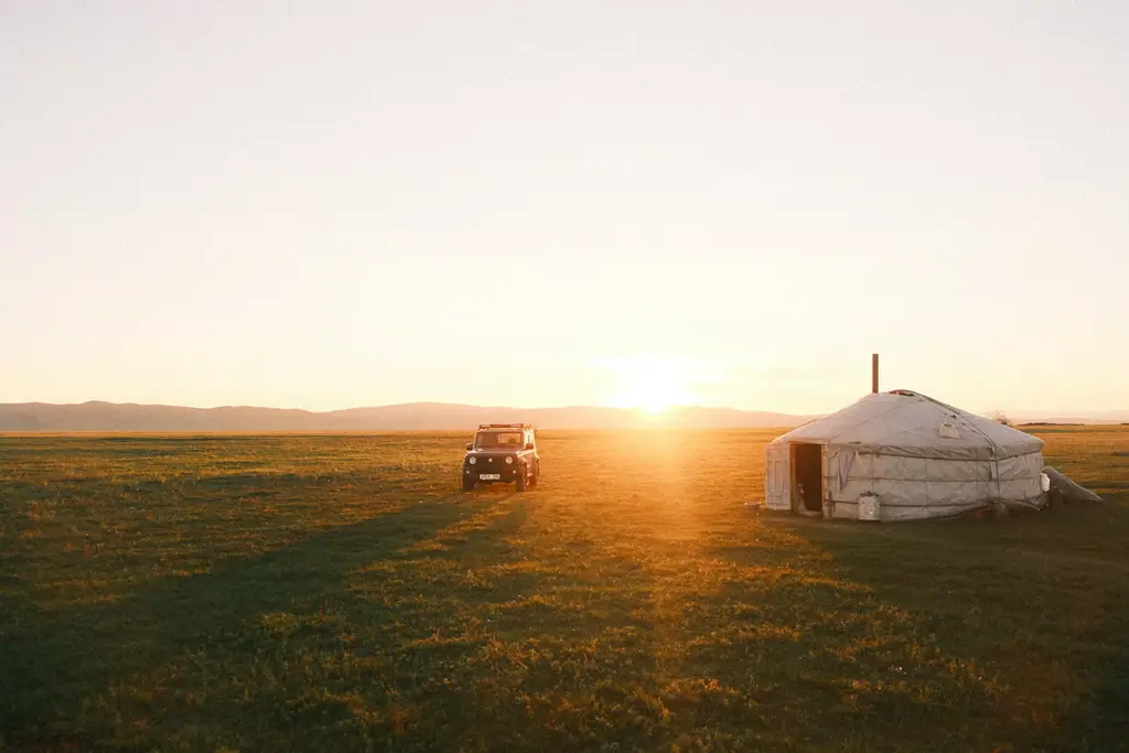 The sun setting behind a lone ger on the steppe
